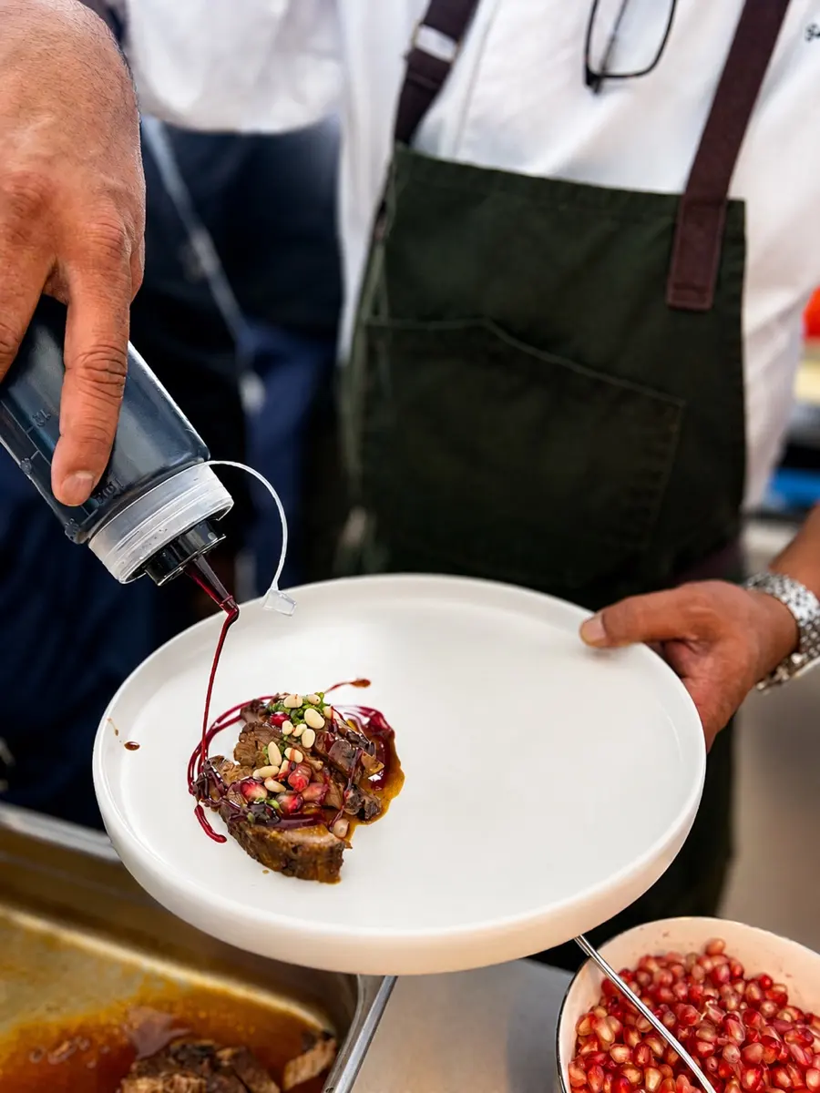 The chef saucing a finished plate