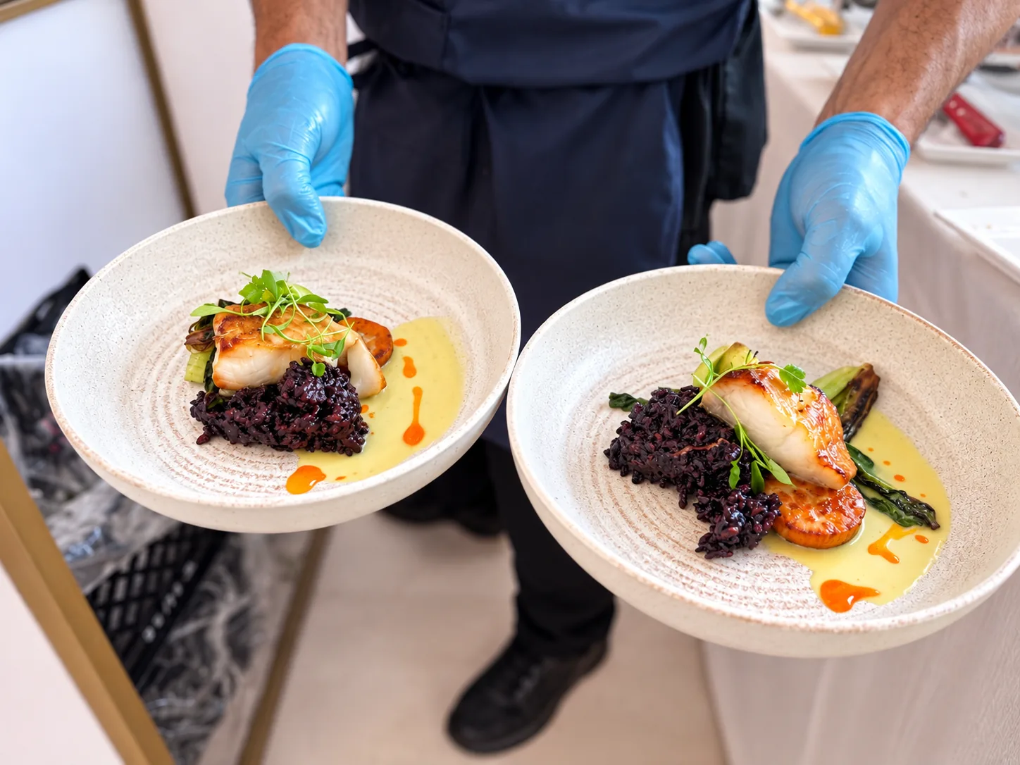 Seared fish on black rice, plated to order